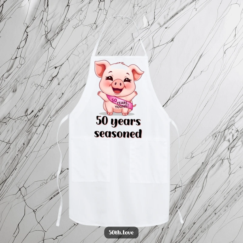 Funny 50th birthday apron featuring a giggling piglet wearing a '50 Years Young' sash, ideal for a humorous cooking experience.