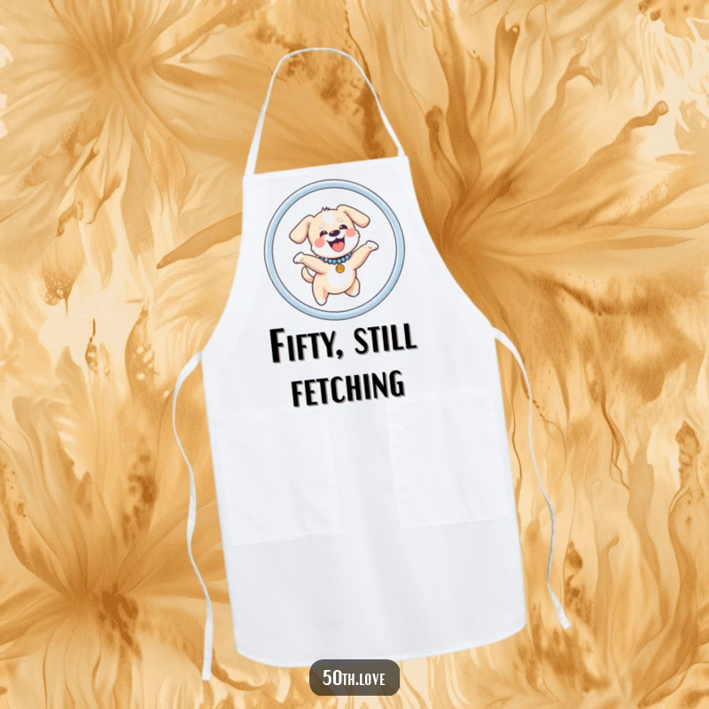 Funny dog apron with a giggling puppy in a sparkly collar, jumping through a hoop shaped like the number fifty, ready to cook.