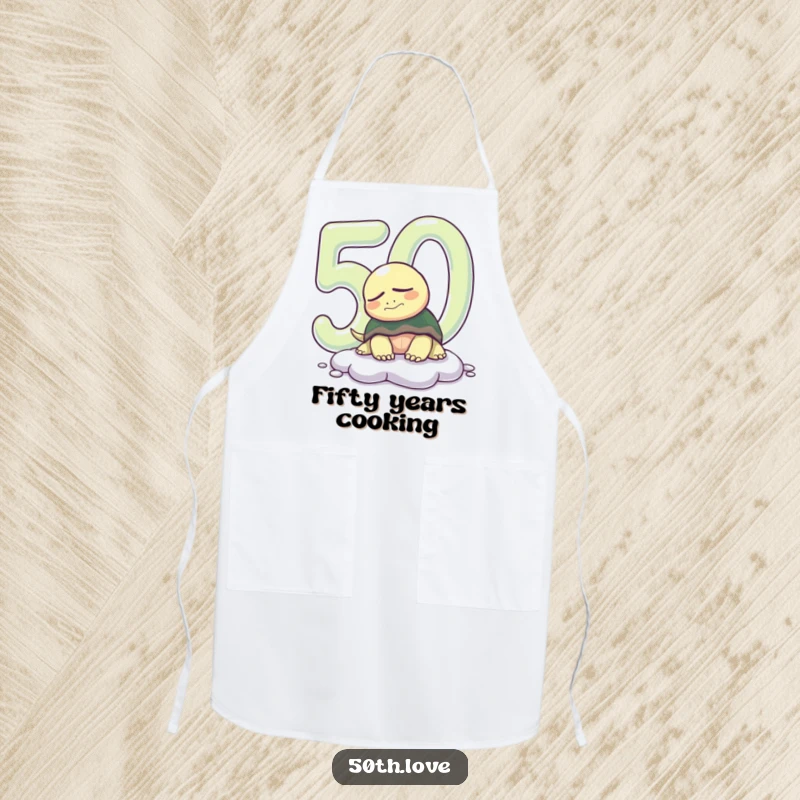 Funny 50th birthday apron showcasing a sleepy turtle emerging from a giant '50', perfect for relaxed cooking sessions.