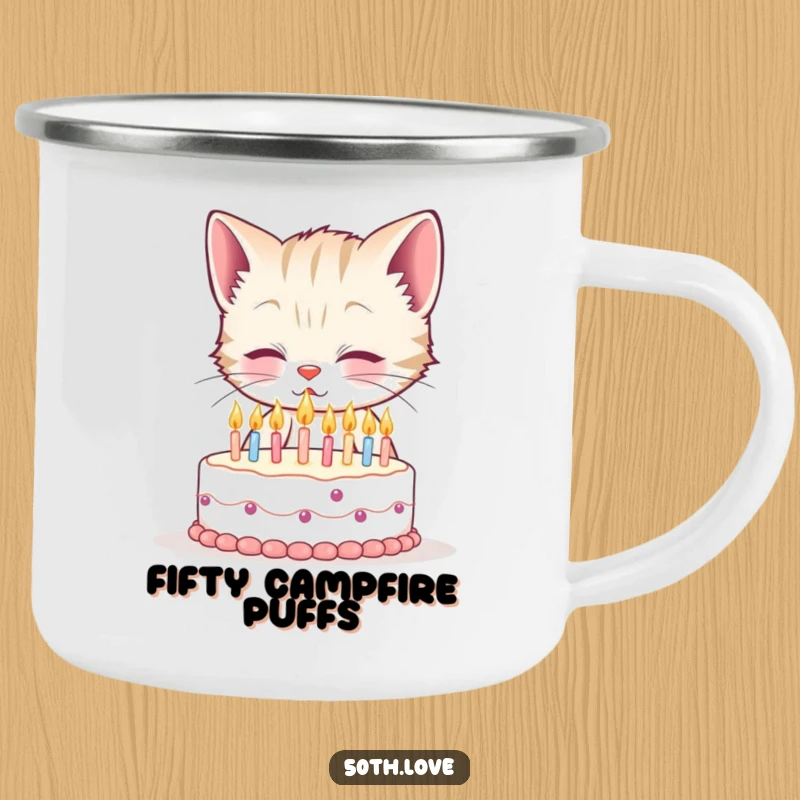 Funny 50th birthday camping mug with a smiling kitten blowing out fifty tiny candles on a miniature cake, for humorous outdoor moments.