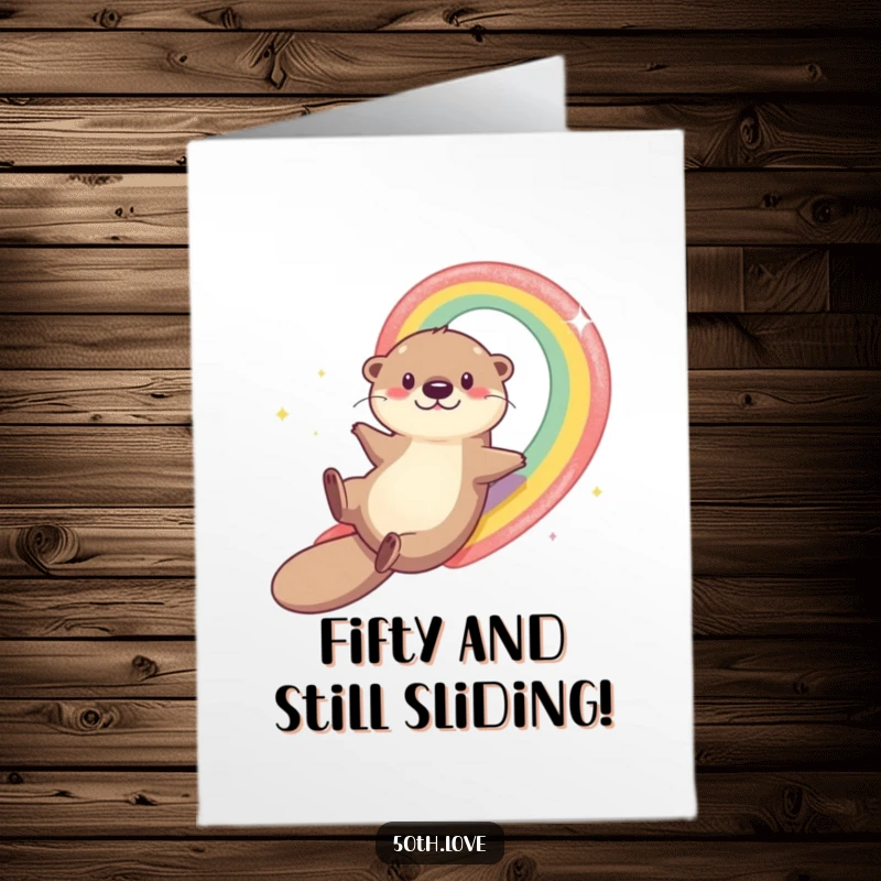Funny Free Printable Birthday Card: Playful otter joyfully slides down a shimmering rainbow number 50.