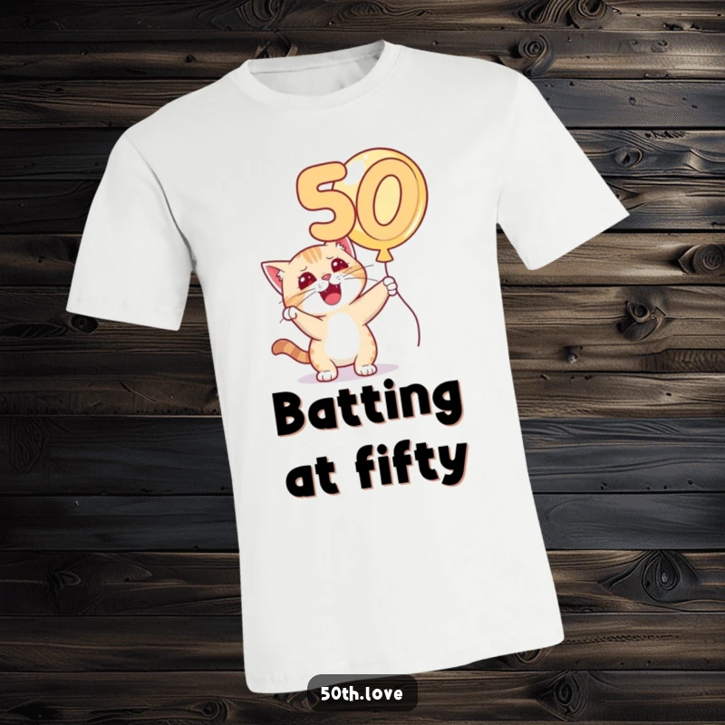 Funny 'Cat 50th Birthday' T-Shirt: A cat with a cheeky grin bats playfully at a large golden number 50 balloon.