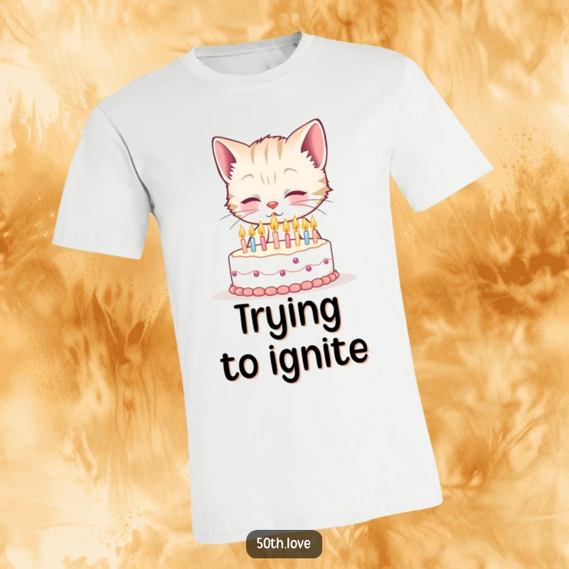 Funny 50th birthday t-shirt with a smiling kitten attempting to blow out fifty tiny candles on a minuscule cake, a humorous depiction.