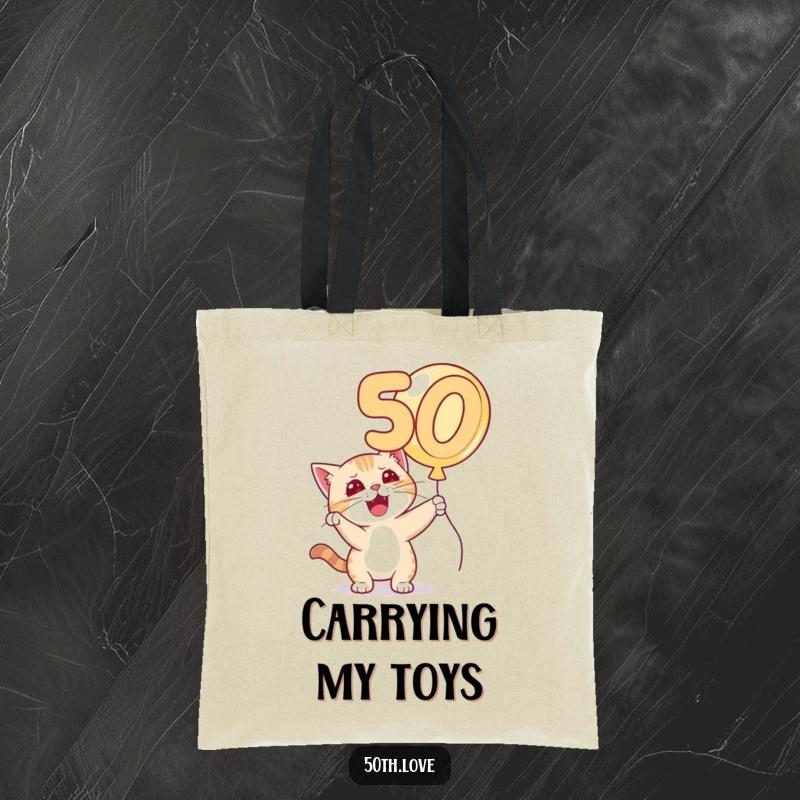 Funny 'Cat 50th Birthday' Tote Bag: A mischievous cat bats playfully at a golden number 50 balloon, full of feline fun.